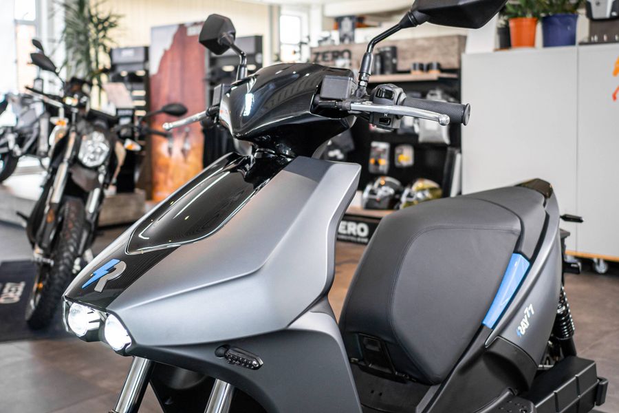 Elektrischer Scooter RAY 7.7 in Grau, Front- und Seitenansicht im Autohaus.