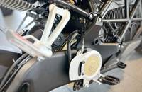 Detailaufnahme des Ladeanschlusses und der Federung eines Motorrads.