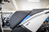 Seitenansicht des RAY 7.7 Motorrads mit schwarzem Sitz und weißer Verkleidung.