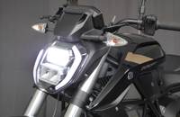 Frontansicht des schwarzen Zero Motorrads. Der Scheinwerfer ist beleuchtet.