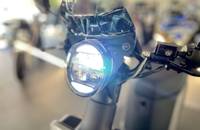 Detailaufnahme des Scheinwerfers und des Lenkkopfes des E-Motorrollers.