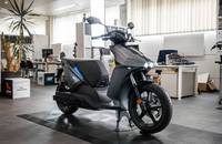 Seitenansicht des grauen E-Scooters RAY 7.7 in einem Showroom.