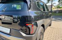 Heckansicht eines schwarzen KIA EV2 auf einem Parkplatz vor dem Autohaus.
