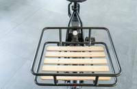 Heckansicht eines schwarzen Lastenrads mit Holzlatten-Träger.