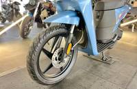Seitenansicht des hellblauen Elektro-Scooters mit Vorderrad und Akku.